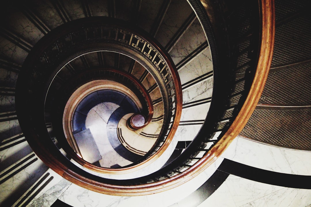 brown spiral staircase with brown wooden railings brown spiral staircase with brown wooden railings