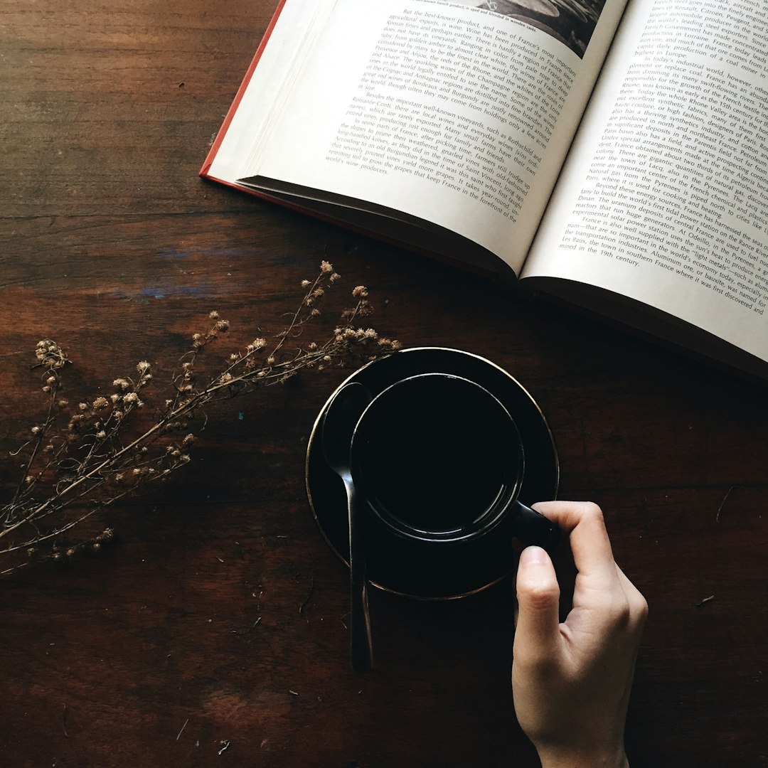 round black metal container near white book open round black metal container near white book open
