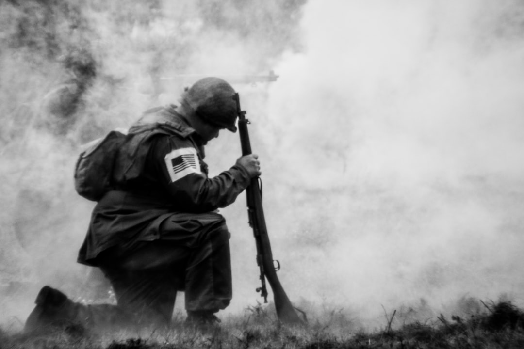 a man holding a rifle in front of a cloud of smoke a man holding a rifle in front of a cloud of smoke