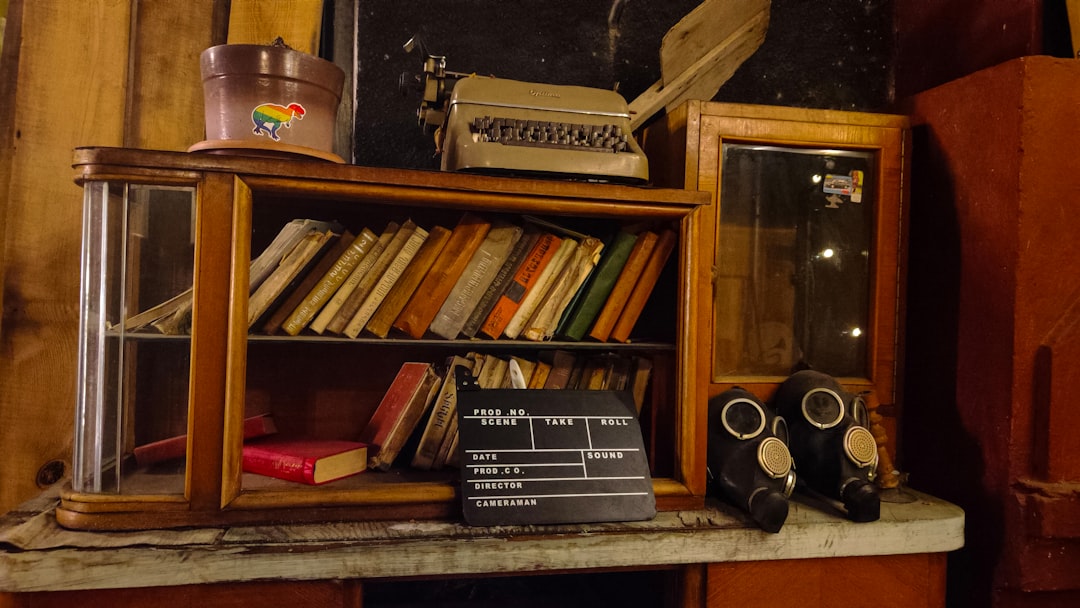 Vintage desk with books, typewriter, gas masks, and clapperboard Vintage desk with books, typewriter, gas masks, and clapperboard